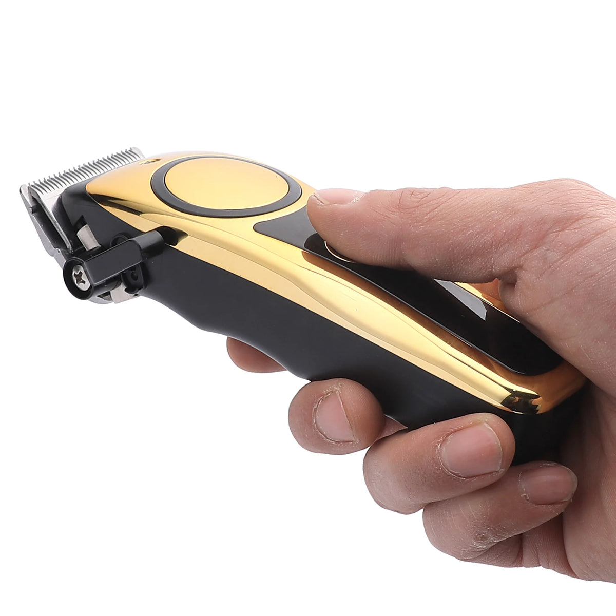 A hand holds a professional LCD hair clipper set with a black and gold body and a metal comb attachment.