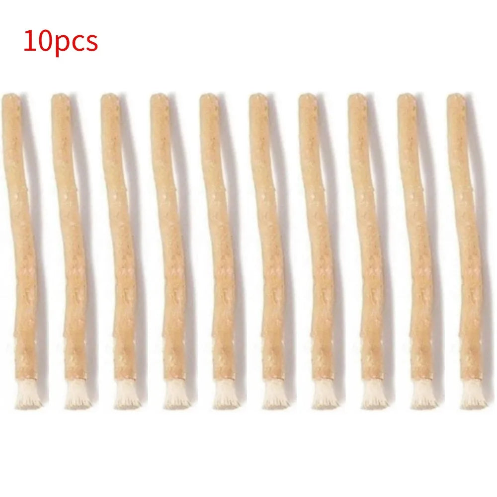 Ten natural miswak toothbrushes with light brown handles and fibrous tips.