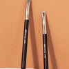A set of GECOMO eyeliner and brow makeup brushes displayed against a peach background.