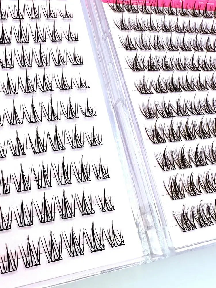 A close-up of individual lash clusters for eyelash extensions shown in various shades and lengths.
