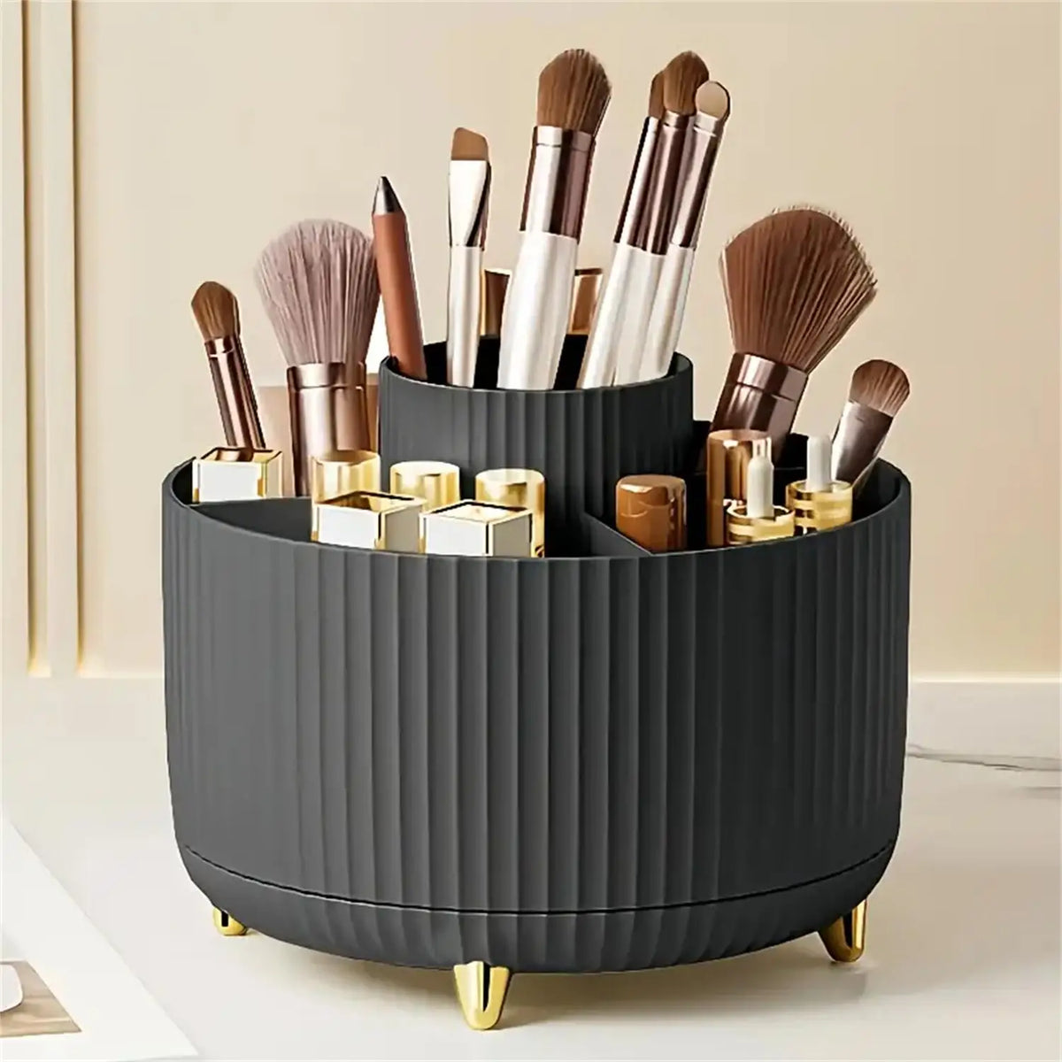 A black rotating makeup organizer holding various makeup brushes and tools.