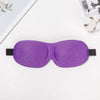 Purple 3D sleep mask for light blocking lying on a white surface.