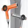 An orange professional salon hair dryer is shown in a vertical orientation against a light gray background.