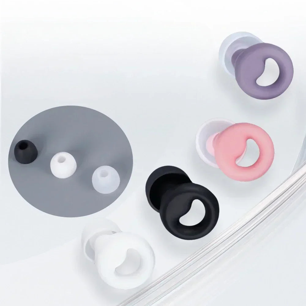 A collection of silicone earplugs in various colors including gray, pink, and white, shown on a white background.