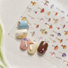 A collection of watercolor mushroom nail art stickers in various pastel and earthy tones arranged on a clear sheet.