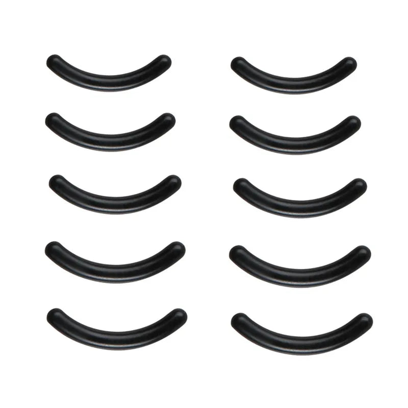 A set of black professional eyelash curlers arranged in a row.