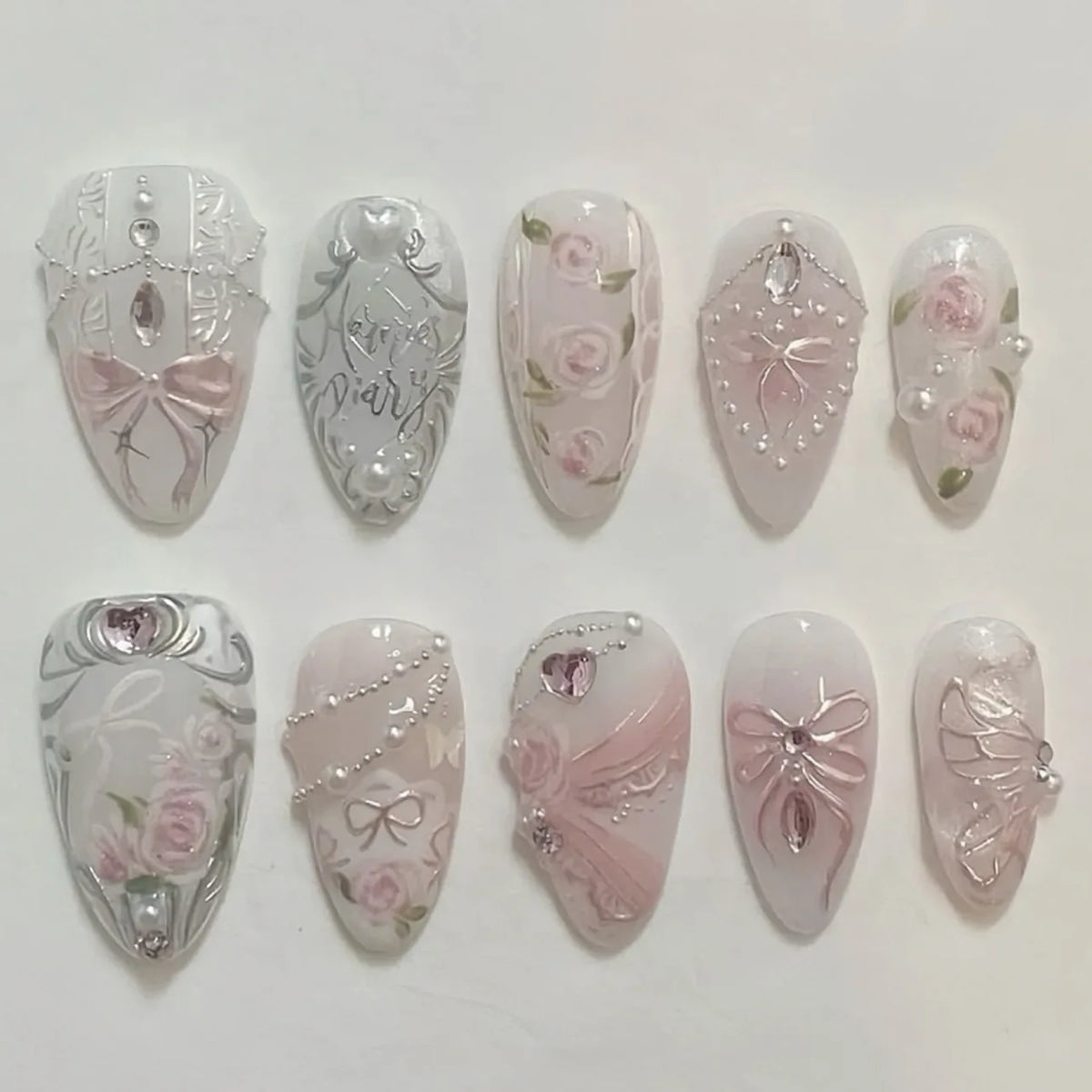 A set of 24 pink heart pearl press-on fake nails featuring floral designs and glitter accents.
