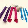 A set of pink and purple heatless hair curlers and a blue curling iron are displayed on a white background.