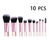 A set of ten pink makeup brushes and tools for travel