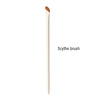 A single light-colored Scythe brush for makeup application.