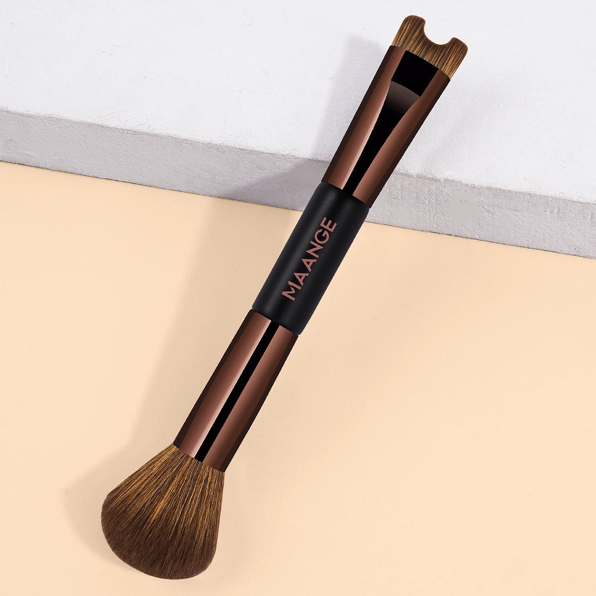 A brown double-ended contouring makeup brush with a wooden handle and synthetic bristles