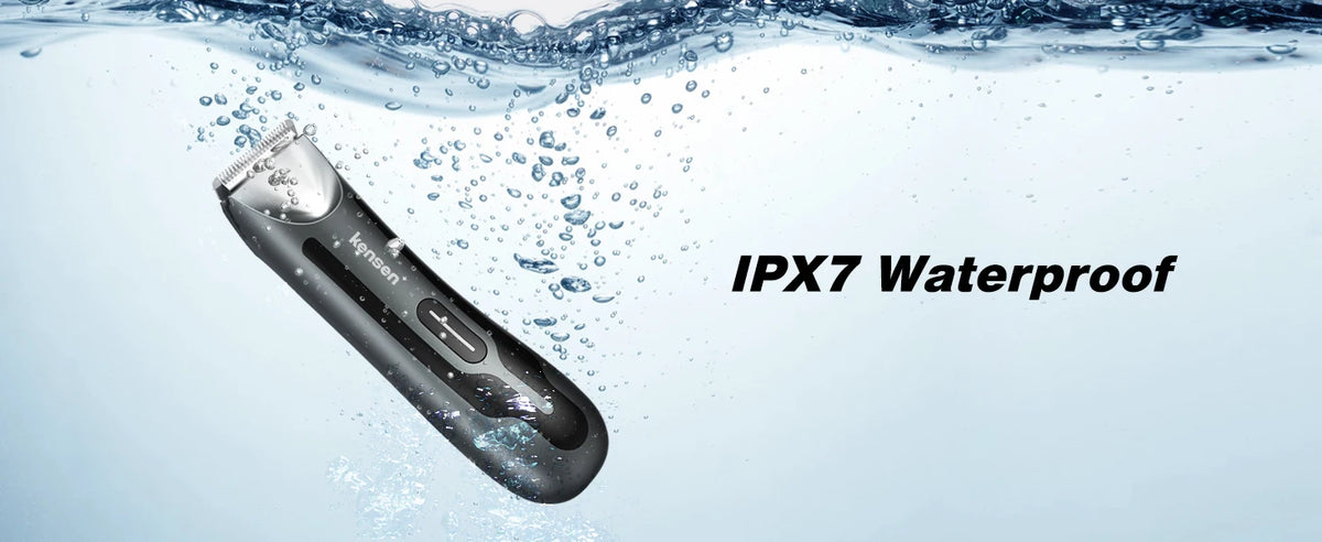 A black electric body hair trimmer with a ceramic blade is shown submerged in clear water droplets.