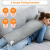 A gray electric heating pad is shown being used on a person's shoulder while lying in bed.