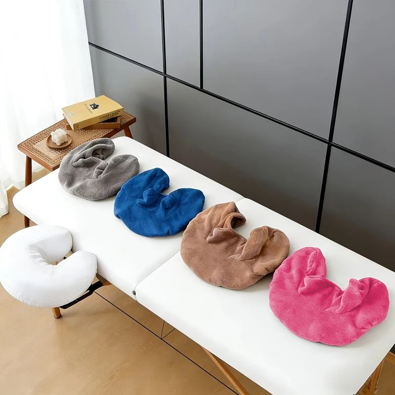 A collection of reusable U-shaped pillow covers in various colors including gray blue and pink resting on a white table.