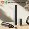 A tall, cylindrical electric nose hair trimmer in matte black is shown next to a smaller version and a separate trimmer head 