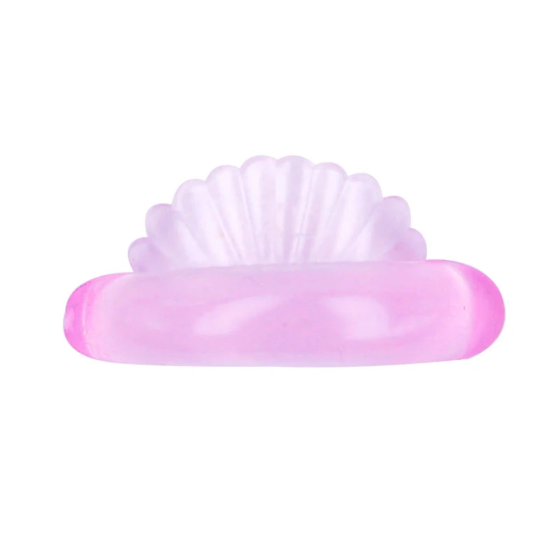 A pink silicone eyelash curler and lifting kit with a fluted tip.