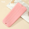 A pink heat resistant silicone mat with a textured surface is shown on a marble background.