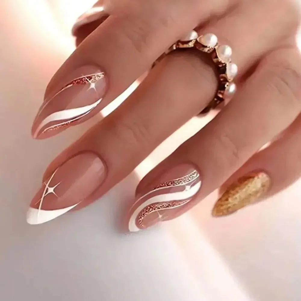 A hand displaying press-on false nails with a French wavy design and pearl ring.