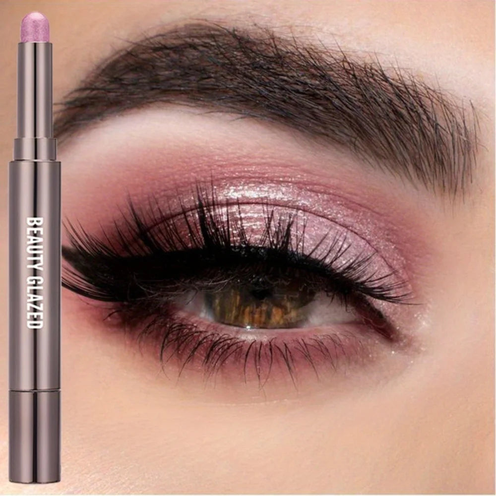 A cosmetic product featuring a long eyeshadow stick in a metallic rose color shown next to an eye makeup look.
