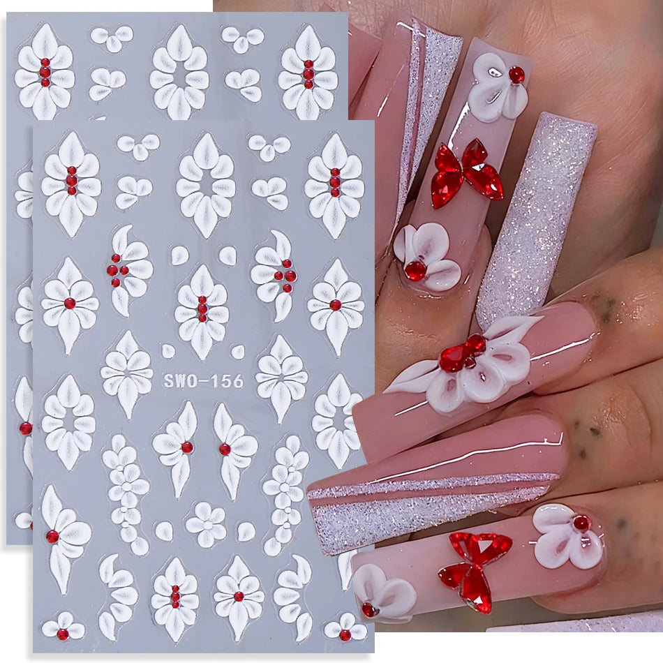 A set of two white floral nail stickers featuring delicate flowers and leaves on a light blue background.