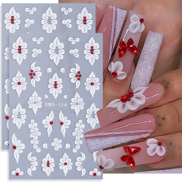 A set of two white floral nail stickers featuring delicate flowers and leaves on a light blue background.