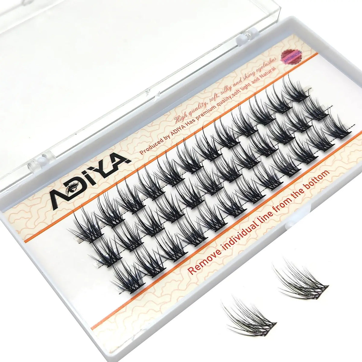 A clear plastic container holding DIY wide stem cluster lashes for natural volume
