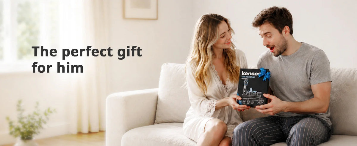 A couple is looking at a black grooming kit for men and body grooming on a sofa.