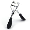 A silver professional eyelash curler with black rubber grips shown against a white background.