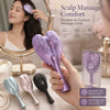 A hand holds a purple air-cushion scalp massage comb with various colored combs in a studio setting.