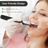 A woman wearing a white glove is using an electric dental scaler kit to clean her teeth.