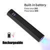 A black portable UV nail lamp with an LCD display and rechargeable battery, showing a glowing light.