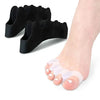 Black soft gel toe separators placed on a foot for bunion relief and toe straightening.
