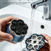 Hands hold a magnetic floating electric head shaver dripping water into a sink basin.