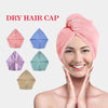 A woman is smiling while wearing a pink dry hair cap, with various colored caps displayed nearby.
