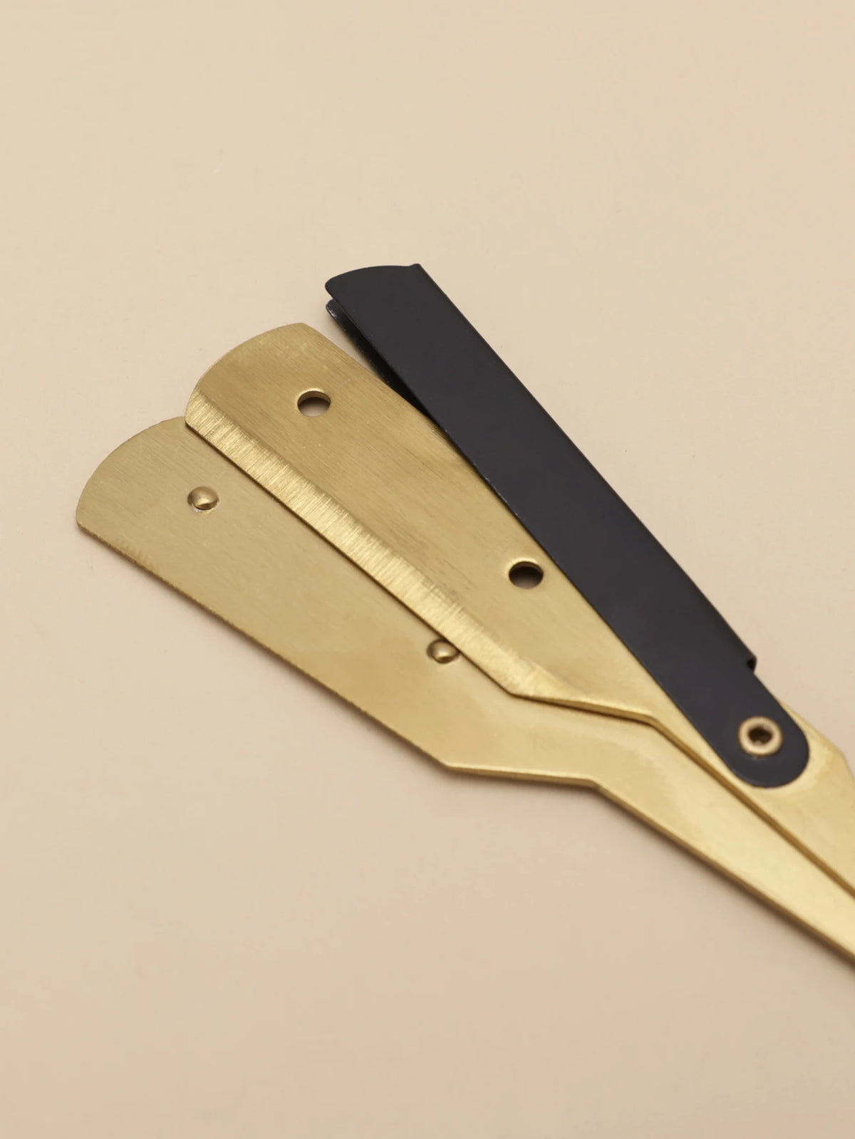A professional stainless steel shaver and beard razor kit with gold and black components.