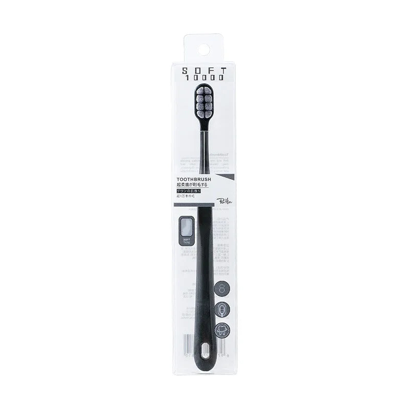 A black soft bristled toothbrush is shown in its packaging box.