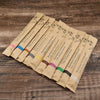 A fan of eco-friendly bamboo toothbrushes packaged in individual cardboard sleeves.