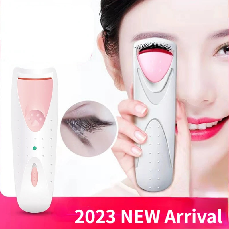 A woman is using an electric heated eyelash curler device to curl her eyelashes for makeup.