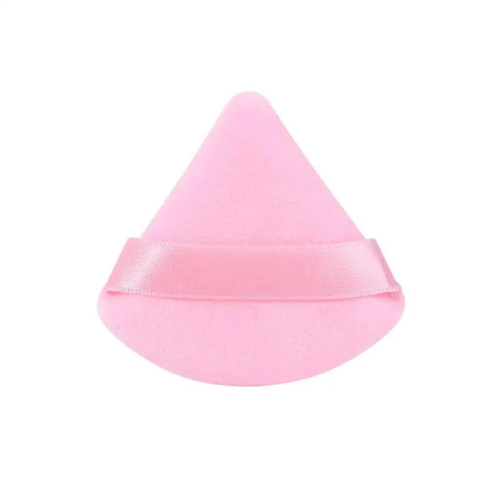 A pink triangular velvet powder puff.