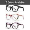 Three pairs of clear cateye reading glasses shown in black, pink floral pattern, and purple floral pattern.