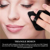 A woman applies makeup to her face using a triangular powder puff tool.
