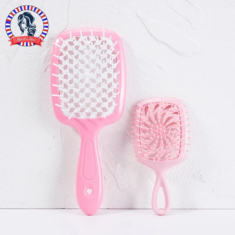 A pink detangling hair comb is shown against a white background.
