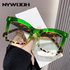 A pair of bright green square-framed reading glasses with brown and white patterned lenses being held by a person.