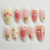 A set of 24 pink heart pearl press-on fake nails featuring a glossy finish and floral accents.