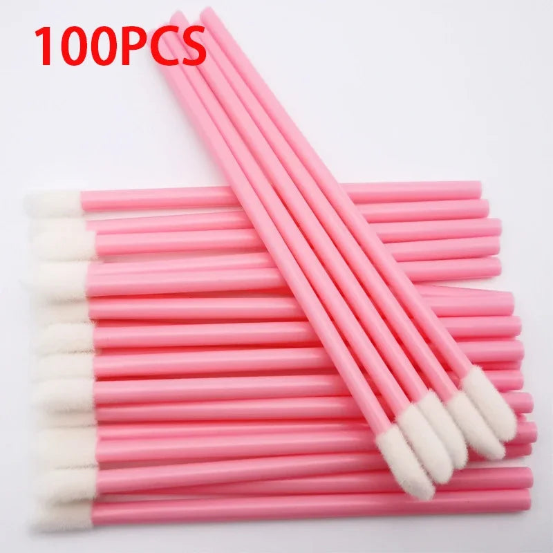 A set of 100 pink precision makeup brushes with white tips arranged in a row.