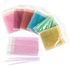A collection of crystal lip brushes in various shades including pink, purple, blue, and green, packaged in clear plastic.