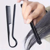 A hand is holding a black V-comb hair styling tool, showing its shape and function for smoothing hair.