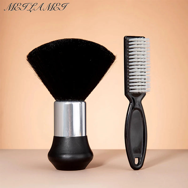 A black professional hair styling and cleaning brush set featuring a wide brush and a comb on a light background.