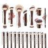 A collection of professional makeup brushes including powder, highlighter, contour, and blending brushes.