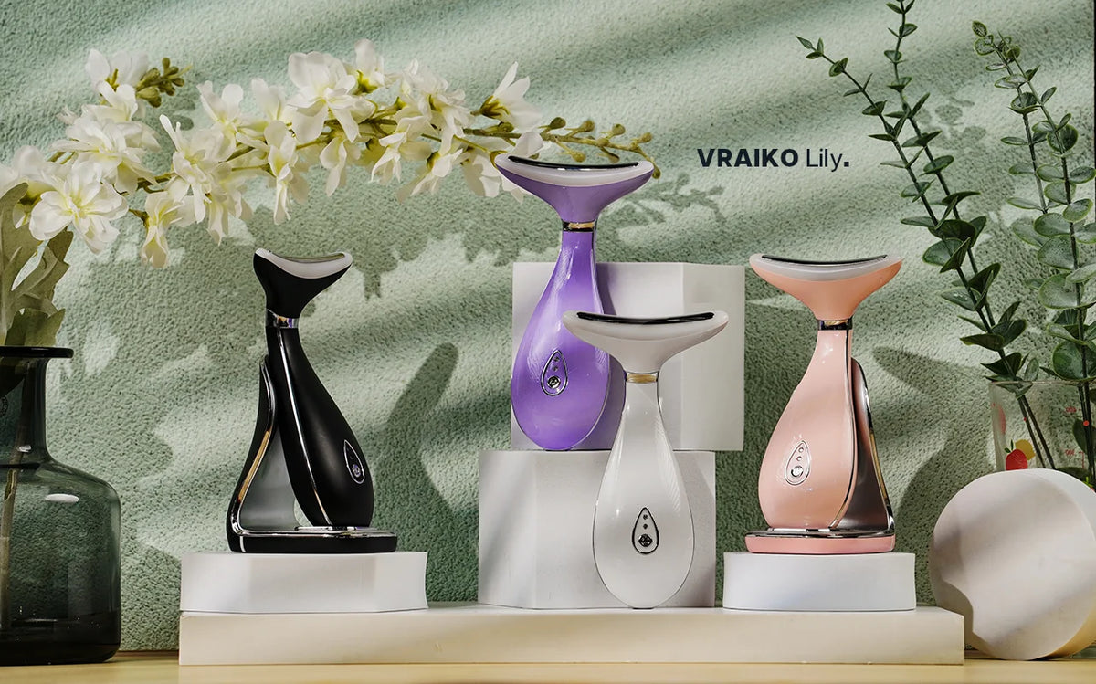 A collection of LED photon therapy neck and face massagers in black, purple, and pink displayed on a white surface.
